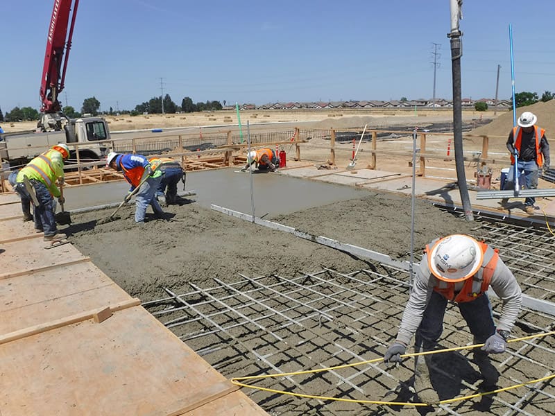 Site preparation and excavation mark the initial phases of constructing a concrete foundation